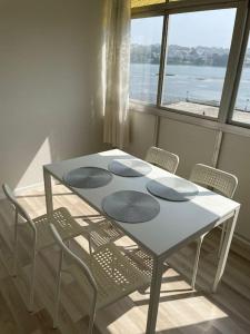 a table and chairs with a table and a window at Vibes Coruña-Paz 16 in Culleredo