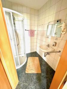 a bathroom with a shower and a sink and a tub at Steirer Haus in Gamlitz