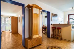 a room with a mirror and a kitchen with a counter at Sonnenstube in Langenargen +22 photos