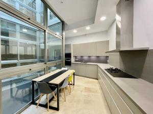 a large kitchen with a table and some chairs at Fdez Amazing House by Cathedral and Giralda with private Pool in Seville