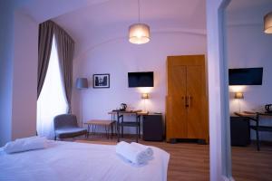 a bedroom with a bed and a table and chairs at Hotel PAYER II in Teplice