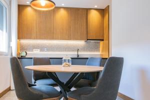 a kitchen with a wooden table and chairs at MM Central luxury in Kolašin