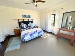 a bedroom with a bed and a ceiling fan at Irina House&BreakerView in Ramsgate