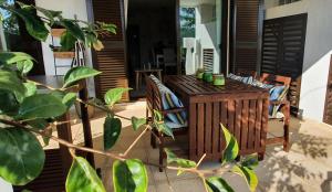 a porch with chairs and a wooden table at La Alcaidesa Valerie & Bruno in San Roque