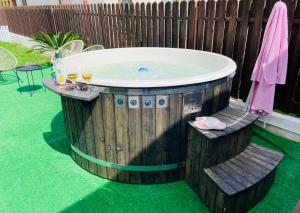 a jacuzzi tub in a backyard with two chairs at B&B Home in Sighişoara