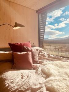 a bedroom with a bed with a view of a field at The Roost in Aviemore