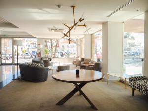 a room with a table and chairs in a building at Hotel Baia in Cascais