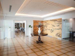 a room with a table and a map on the wall at Hotel Baia in Cascais
