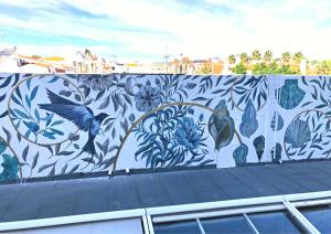 a mural on a wall with birds and flowers at Hotel Baia in Cascais