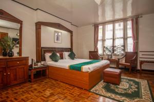 a bedroom with a bed and a table and chairs at Central Hill Resort The Mall Road in Gangtok +54 photos