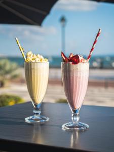 two milkshakes sitting on top of a table at Hotel Baia in Cascais