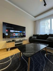a living room with a large flat screen tv at Trump Tower - Cevahir Shopping Center - Şişli Metro İki yatak odalı Klimalı Tüm Daire in Istanbul