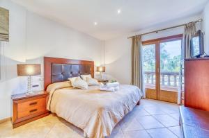 a bedroom with a large bed and a window at Ideal Property Mallorca - Son Morei Gran in Muro