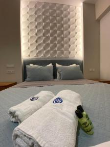 a bedroom with two towels on a bed at Castro Hotel in Amoudara Herakliou