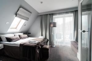 Кровать или кровати в номере NovaWisła Resort & SPA