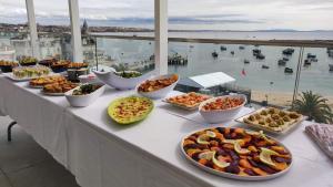 a buffet with many different types of food on a table at Hotel Baia in Cascais