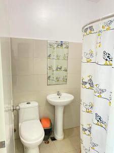 a bathroom with a toilet and a sink at SK's Crib - Fully Furnished Condo @ Primavera Apts in Cagayan de Oro