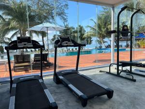 a gym with two treadmills and a swimming pool at SCARLET SAILS VILLA in Koh Rong Island