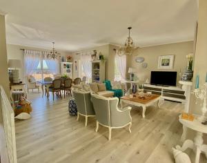 a living room with a couch and a table at Ocean and mountain breeze in Hermanus