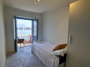 a bedroom with a bed and a view of the water at Luxury Villa Olga in Stresa in Baveno