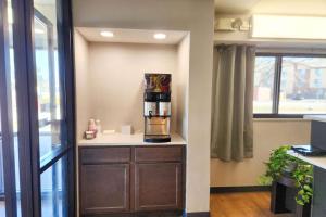 a coffee maker sitting on a counter in a room at Travelodge by Wyndham Peoria in Peoria