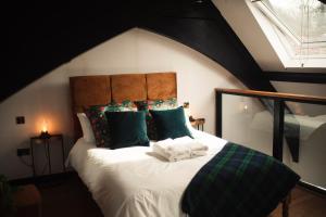 a bedroom with a large bed with green pillows at Slateford House 1770 by The House of Danu in Edinburgh