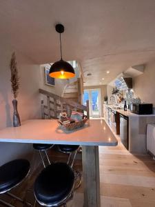 a kitchen with a table and chairs in a room at Sea View Nook in Porthtowan