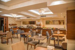 a restaurant with tables and chairs and a kitchen at Le Mirage Hotel in Istanbul