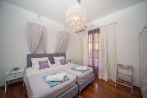 A bed or beds in a room at Avlaki Beach House,stylish villa in Kassiopi