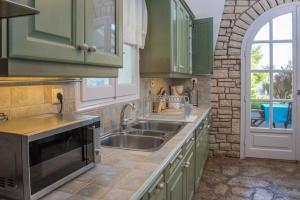 A kitchen or kitchenette at Avlaki Beach House,stylish villa in Kassiopi