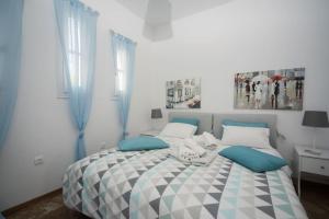 A bed or beds in a room at Avlaki Beach House,stylish villa in Kassiopi