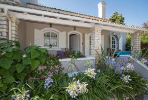 A garden outside Avlaki Beach House,stylish villa in Kassiopi