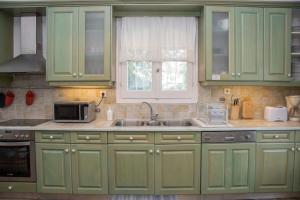 A kitchen or kitchenette at Avlaki Beach House,stylish villa in Kassiopi