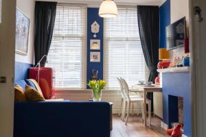 sala de estar con paredes azules y mesa con silla en Het Kasteeltje, en Vlissingen