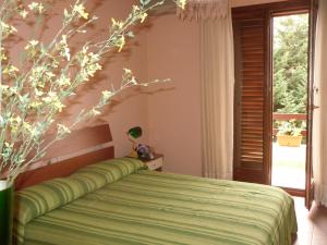 A bed or beds in a room at La ginestra Chia B&B