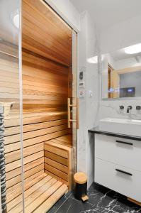 a bathroom with a wooden shower and a sink at Apartament Szafirowy z BEZPOŚREDNIM WIDOKIEM na morze- Nadmorski Luksus Apartamenty in Ustronie Morskie