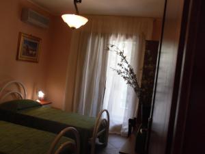 A bed or beds in a room at La ginestra Chia B&B