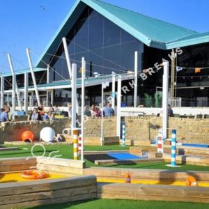 a large building with a playground in front of it at Goldfinch - Spacious 2 bed at Seal Bay in Selsey