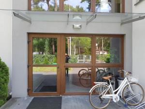 a bike parked in front of a door at Villa VIP Jurata in Jurata