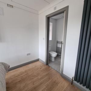 an empty room with a toilet and a doorway at Beach Chalet, Little Walsingham Norfolk in Little Walsingham +40 photos