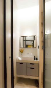 a bathroom with a sink and a mirror at Modern apartment in City Centre in Seville