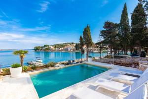 a swimming pool with a view of the water at House with pool by the sea - Dugi otok, Žman in Žman