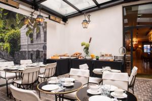 a restaurant with tables and chairs and a counter at Mom'Art Hotel in Paris