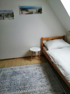 a bedroom with a bed and a table and a rug at Appartement bei Schloß Ulmerfeld 
