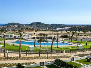 a resort with two pools and palm trees at Apartment Seascape Relax in Finestrat