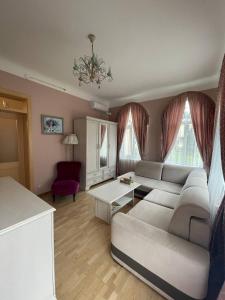 a living room with a couch and a table at Guest house, Jūrmala in Jūrmala