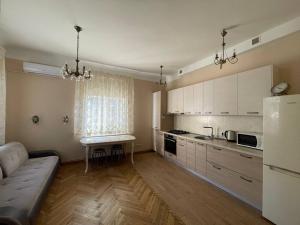 a kitchen with a couch and a table in a room at Guest house, Jūrmala in Jūrmala