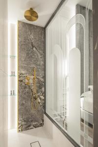 a bathroom with a shower and a glass wall at Bella Venezia in Corfu