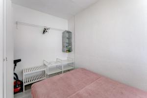 a small bedroom with a bed and a pink blanket at Cozy apartment in Costa del Silencio in Costa Del Silencio +11 photos