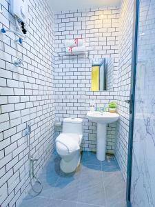 a white bathroom with a toilet and a sink at Astar Hotel Bukit Bintang in Kuala Lumpur